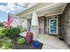 Inviting front porch with decorative stone columns, charming decor, and colorful plants enhancing curb appeal at 8126 Kilborn Way, Avon, IN 46123