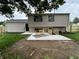 Tan two-story home with new concrete patio, black door, basement access, and fresh landscaping in backyard at 8277 N Waterford Dr, Columbus, IN 47201