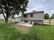 Backyard showcasing a newly built patio, wooden fence, and a well-manicured lawn at 8277 N Waterford Dr, Columbus, IN 47201