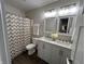 Bright bathroom with a double sink vanity, modern fixtures, and a stylish shower curtain at 8277 N Waterford Dr, Columbus, IN 47201