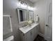 Bathroom featuring double sinks, modern fixtures, and stylish design with white cabinets and marble countertops at 8277 N Waterford Dr, Columbus, IN 47201