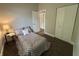 Neutral bedroom with brown and white geometric patterned comforter, side table and bedside lamp at 8277 N Waterford Dr, Columbus, IN 47201