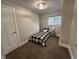 Simple bedroom with black and white checked bedspread, side table and bedside lamp at 8277 N Waterford Dr, Columbus, IN 47201