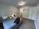 Clean bedroom featuring carpeted floors, a cozy bed, walk-in closet and modern lighting at 8277 N Waterford Dr, Columbus, IN 47201