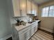 Well-lit kitchen with white cabinets, a stainless steel sink, marble-patterned countertops, and modern appliances at 8277 N Waterford Dr, Columbus, IN 47201