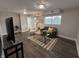 Cozy living room featuring a comfortable couch, chair, and stylish rug in a well-lit basement at 8277 N Waterford Dr, Columbus, IN 47201