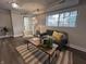 Basement living room featuring a comfortable couch, chair, rug, and a view from the window at 8277 N Waterford Dr, Columbus, IN 47201