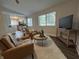 Cozy living room with stylish furniture, neutral tones, and an open floor plan leading to a modern kitchen at 8277 N Waterford Dr, Columbus, IN 47201