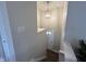 Staircase featuring neutral walls, handrail and chandelier leading to the front door at 8277 N Waterford Dr, Columbus, IN 47201