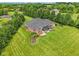 Lush backyard features a hot tub, covered patio, meticulous landscaping, and established trees, perfect for outdoor relaxation at 8301 Cooper Ln, Zionsville, IN 46077