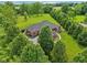 Aerial view of a home with a well manicured lawn, mature landscaping and a paved drive way at 8301 Cooper Ln, Zionsville, IN 46077
