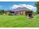 Spacious backyard featuring a patio area, hot tub, lush lawn, and well-maintained landscaping at 8301 Cooper Ln, Zionsville, IN 46077