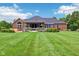 Wide shot of a large backyard featuring a patio, pergola, hot tub, and meticulously maintained lawn at 8301 Cooper Ln, Zionsville, IN 46077