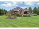 A sprawling backyard showcases lush landscaping, a hot tub, a patio, and a charming pergola, perfect for outdoor living at 8301 Cooper Ln, Zionsville, IN 46077
