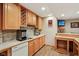 Basement bar area with wood cabinetry, wine rack, tile backsplash, and a built in sink at 8301 Cooper Ln, Zionsville, IN 46077