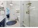Well-lit bathroom featuring a glass shower, a soaking tub and dark blue accents at 8301 Cooper Ln, Zionsville, IN 46077