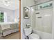 Ensuite bathroom featuring a shower-tub combo, and serene views of the adjacent bedroom at 8301 Cooper Ln, Zionsville, IN 46077