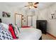Bedroom showcasing a bed with red accents, dark furniture, and multiple doorways at 8301 Cooper Ln, Zionsville, IN 46077
