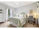 Cozy bedroom featuring a comfortable bed, a dedicated workspace, and soft natural light at 8301 Cooper Ln, Zionsville, IN 46077