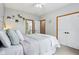 Bedroom with soft blue walls, plush bedding, and easy access to a private bathroom at 8301 Cooper Ln, Zionsville, IN 46077