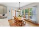 Inviting dining space with modern light fixture, hardwood floors, and scenic window views at 8301 Cooper Ln, Zionsville, IN 46077