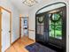 Elegant entryway with hardwood floors, double doors, and natural light, creating a grand entrance at 8301 Cooper Ln, Zionsville, IN 46077