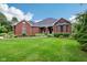 Well-maintained brick home featuring a manicured lawn and beautiful landscaping at 8301 Cooper Ln, Zionsville, IN 46077