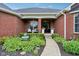 Charming front entrance with brick facade, elegant landscaping, and a welcoming walkway at 8301 Cooper Ln, Zionsville, IN 46077