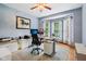 Bright home office featuring a work space with dual monitors, light blue walls, and natural light from the bay window at 8301 Cooper Ln, Zionsville, IN 46077