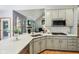 Well-equipped kitchen with white quartz counters, modern appliances, and a view to living room at 8301 Cooper Ln, Zionsville, IN 46077