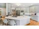 Stylish kitchen with gray cabinets, quartz countertops, stainless steel appliances, and center island at 8301 Cooper Ln, Zionsville, IN 46077