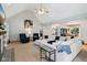 Open concept living area featuring a large white sectional sofa, vaulted ceilings, and modern decor at 8301 Cooper Ln, Zionsville, IN 46077