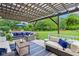 Spacious outdoor patio featuring comfortable lounge seating, pergola, and scenic backyard views at 8301 Cooper Ln, Zionsville, IN 46077