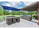 Outdoor patio and dining area shaded by a blue umbrella and pergola, perfect for entertaining and relaxing at 8301 Cooper Ln, Zionsville, IN 46077