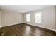 This bedroom features wood-look flooring, large windows, and neutral walls at 8310 Becks Mill Ln, Indianapolis, IN 46113