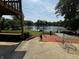 Lush backyard with a clear view of the lake and a dock, as seen from the back patio at 8664 S Nash Dr, Nineveh, IN 46164