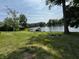 A backyard with a firepit, a boat dock, and a peaceful water view at 8664 S Nash Dr, Nineveh, IN 46164