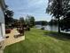 Expansive backyard with lake view, features a well-maintained lawn, patio area, and mature trees at 8664 S Nash Dr, Nineveh, IN 46164