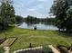 Scenic backyard view of the lake and a well-manicured lawn at 8664 S Nash Dr, Nineveh, IN 46164