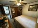 Comfortable bedroom with neutral tones, wood furniture, and view into living room at 8664 S Nash Dr, Nineveh, IN 46164