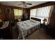 Comfortable bedroom with wood paneling, natural light, and vintage decor at 8664 S Nash Dr, Nineveh, IN 46164