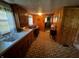 Narrow, wood-paneled kitchen with a white countertop and patterned linoleum flooring and lots of natural light at 8664 S Nash Dr, Nineveh, IN 46164