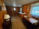 Cozy, wood-paneled kitchen with classic appliances, a kitchen table and chairs, and lots of natural light at 8664 S Nash Dr, Nineveh, IN 46164