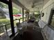 Relaxing screened porch with swing, chairs, ceiling fan, and neighborhood views at 8664 S Nash Dr, Nineveh, IN 46164
