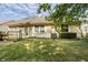 View of the backyard featuring green grass, a home's exterior, and a partial deck with stairs at 8753 Champions Dr, Indianapolis, IN 46256