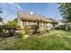 Wide backyard with a patio deck that features stairs, lush landscaping, and green grass at 8753 Champions Dr, Indianapolis, IN 46256