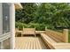 A wood deck with benches and lush landscaping, with a partial view of the home's exterior at 8753 Champions Dr, Indianapolis, IN 46256