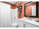 Bathroom featuring a vanity with quartz countertops and a shower/tub with an orange accent wall at 8753 Champions Dr, Indianapolis, IN 46256
