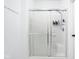 Bright bathroom featuring a shower with a glass door and a built-in seat at 8753 Champions Dr, Indianapolis, IN 46256