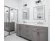 Well-lit bathroom with double vanity, quartz countertops, and modern fixtures at 8753 Champions Dr, Indianapolis, IN 46256